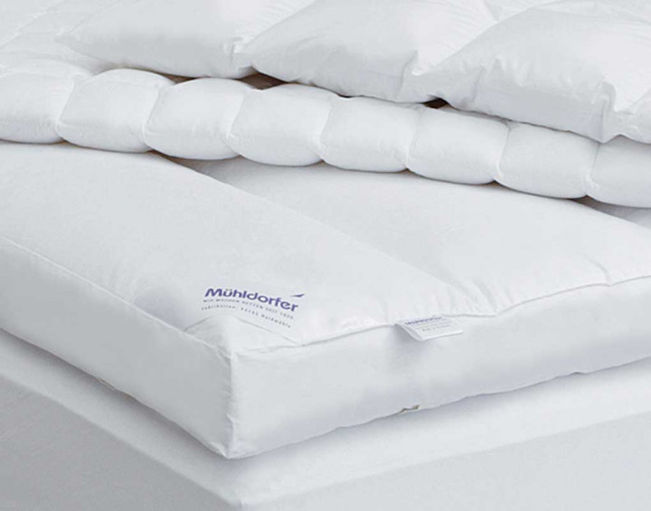 a white mattress on a bed